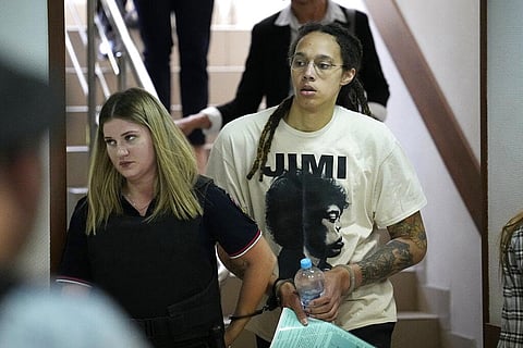 WNBA star and two-time Olympic gold medalist Brittney Griner is escorted to a courtroom for a hearing, in Khimki just outside Moscow, Russia. (Photo | AP)