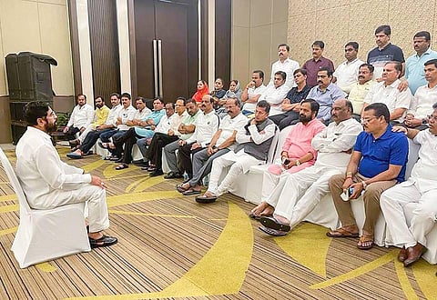 Rebel Shiv Sena leader and Maharashtra CM Eknath Shinde interacts with supporting MLAs at a hotel, in Guwahati. (Photo | PTI)