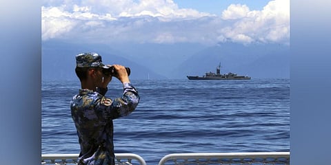 People's Liberation Army member looks through binoculars during military exercises. (Photo | AP)