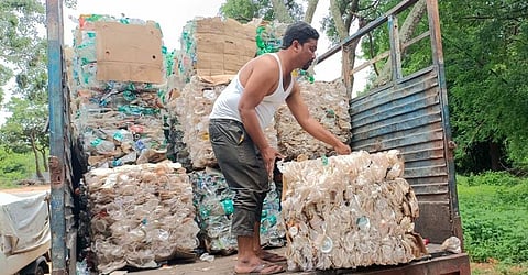 A Swachh Sevak loads the compressed plastic waste strewn by visitors to the Amrabad Tiger Reserve on a truck