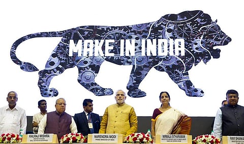 Indian Prime Minister Narendra Modi, centre, unveils the logo of the 'Make in India' initiative in New Delhi, India, Sept. 25, 2014.