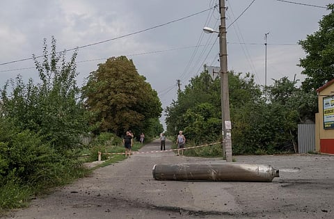 People look on near a cordonned-off piece of rocket that landed earlier, in Kramatorsk amid the Russian invasion of Ukraine.(Photo | AFP)