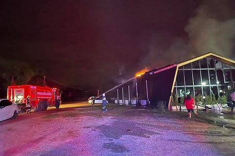 This handout photo taken by the Sawang Rojanathammasathan Rescue Foundation shows firefighters working to contain a fire at the Mountain B nightclub in Sattahip district in Thailand's Chonburi provinc