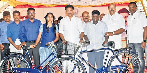 School education minister Anbil Mahesh Poyyamozhi handing over free bicycles to students at a function in Thanjavur on Monday | Express