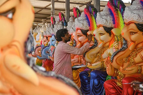 An artist gives final touches to idols of Lord Ganesh at Nunna near Vijayawada on Tuesday. Cost of a 10 feet idol costs in Rs 25,000-Rs 30,000 range. (Photo| Prasant Madugula)