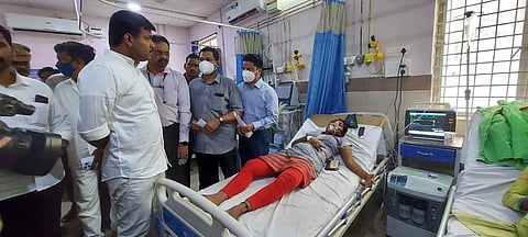 Minister for industries Gudivada Amarnath interacting with gas leak victims at NTR area hospital at Anakapalle on Wednesday. (Photo | EPS)