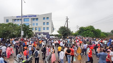 Students gather outside an exam centre after the Common University Entrance Test