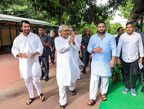 Janata Dal (United) leader Nitish Kumar with Rashtriya Janata Dal leaders Tejashwi Yadav and Tej Pratap, in Patna, Tuesday, Aug. 9, 2022. (Photo | PTI)