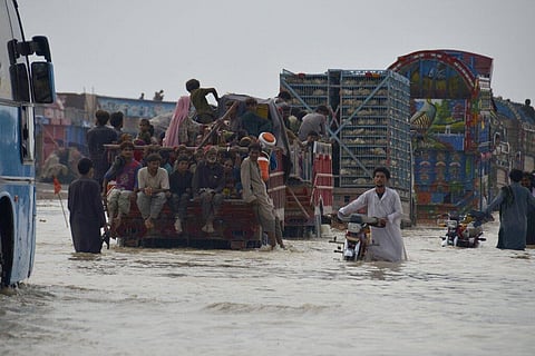 Displaced Pakistani families from flood hit areas board vehicles while they move to safe place, in Nasirabad, a district of Pakistan's southwestern Baluchistan province. (Photo | AP)