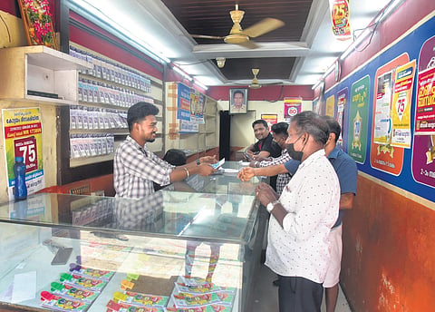 Representative image of customers buying lottery tickets