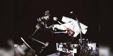A screen at the Beijing Aerospace Control Center in Beijing shows Chinese astronaut Cai Xuzhe conducting extravehicular activities, also known as a spacewalk. (Photo | AP)