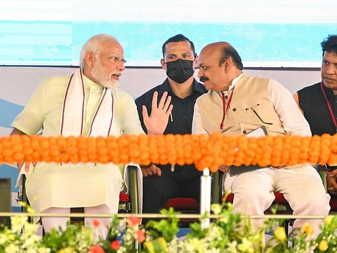PM Narendra Modi speaking with Karnataka CM Basavaraj Bommai after launching projects at Goldfinch City at Bangrakulru in Mangaluru.