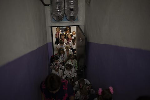 Students leave a shelter after an evacuation training during their first day of school at a public school in Irpin, Ukraine, Thursday, Sept. 1, 2022. (Photo | AP)