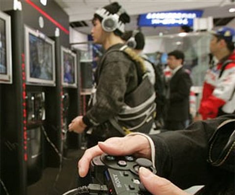 Visitors at the Sony Building in downtown Tokyo play Sony's next-generation video game Playstation 3. AP