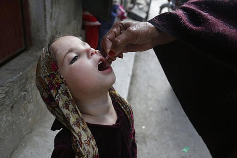 In this March 16, 2020 file photo, a health worker gives a polio vaccine to a child in Lahore, Pakistan.(Photo | AP)