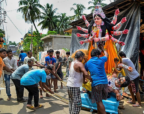 A clay model of Goddess Durga being loaded into a lorry for transportation to Kolkata, ahead of the Durga Puja celebrations, in Nadia. (Photo | PTI)