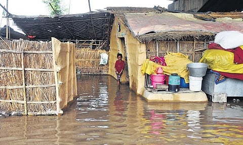 A swollen Yamuna flooded low-lying areas along riverbanks on Tuesday, prompting authorities to evacuate hundreds of people and suspend rail traffic movement on the Old Yamuna Bridge | Parveen Negi