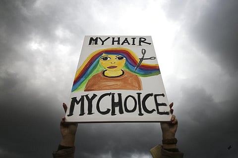 A woman holds a placard during a protest against the death of Iranian Mahsa Amini, in Berlin, Germany, Sept. 28, 2022. (Photo |AP)
