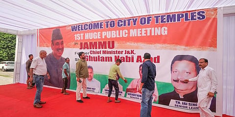 Supporters install a hoarding of former J&K chief minister Ghulam Nabi Azad ahead of his public meeting, in Jammu. (Photo |PTI)