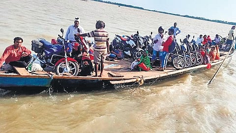 In violation of safety guidelines, a country boat ferries people and motorcycles in Chilika lake | Ranjan Ganguly