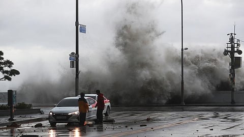 Waves crash over the breakwater in Busan (Photo | AP)
