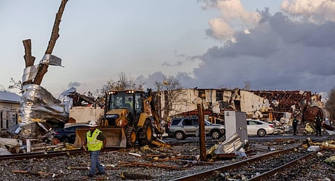 Workers remove debris from railroad tracks after a tornado passed through downtown Selma. (Photo | AP)