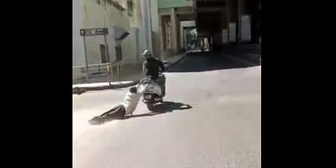 A screengrab from a video which shows the man being dragged by the scooterist. (Screengrab)