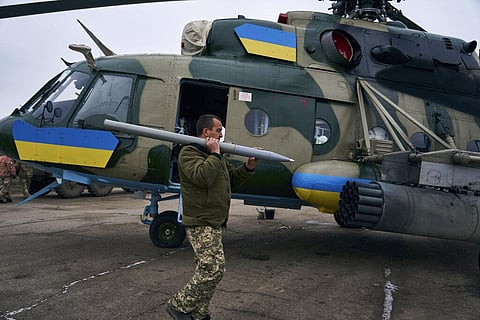A soldier loads the weapon in a helicopter at a Ukrainian military air base close to the frontline in the Kherson region, Ukraine, Sunday, Jan. 8, 2023. (Photo | AP)