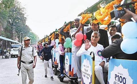 Minister T Harish Rao waves as he take a train ride after inaugurating the 82nd All India Industrial Exhibition at Nampally Exhibition Grounds in Hyderabad on Sunday;Vinay Madapu