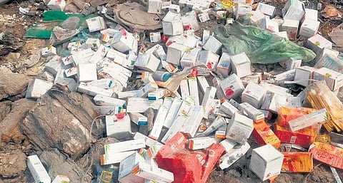 Dumped medicine boxes lying scattered on Mahanadi riverbank | Express