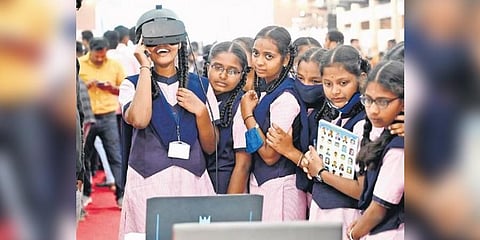  A girl student enjoys a virtual reality experience during the Science Expo 2023 at Palace Grounds in Bengaluru