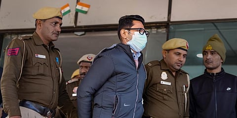 Shankar Mishra being taken away by the police from the DCP office at IGI Airport. (Photo | PTI)