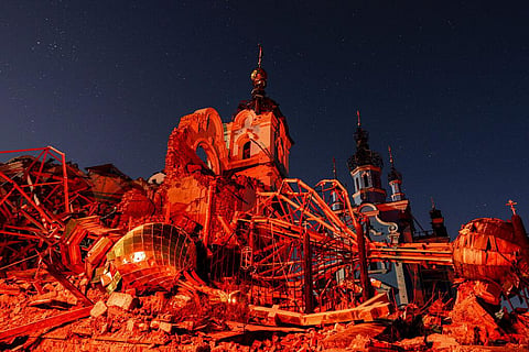 A cupola lies on the ground in front of the Orthodox Church which was destroyed by Russian forces in the recently retaken village of Bogorodychne, Ukraine, Jan. 7, 2022. (Photo | AP)