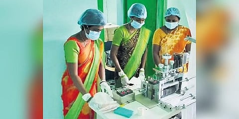 Women are seen manufacturing sanitary napkins in Konaimakula village