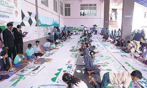 The 720-feet-long painting on canvas completed by 186 tribal students in Attappadi on Monday.