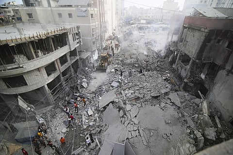 Palestinians inspect the damage of destroyed building after Israeli airstrikes in Khan Younis, Gaza Strip, Tuesday, Oct. 10, 2023. (Photo | AP)
