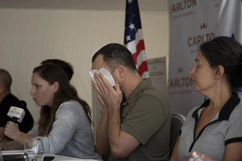 Nahal Neta, son of Adrienne Neta, 66, a nurse missing since a Hamas attack, weeps during a news conference by US citizens in Tel Aviv, Oct 10, 2023. (Photo | AP)