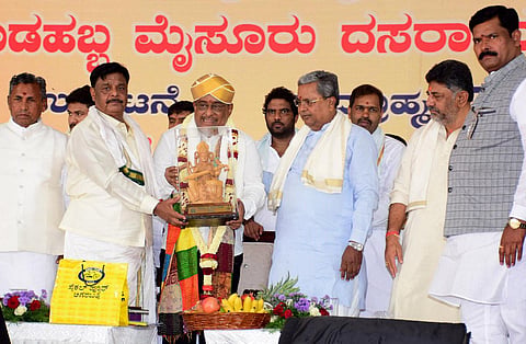Chief Minister Siddaramaiah felicitates music director Hamsalekha, who inaugurated the Dasara festivities in Mysuru. (Photo | Udayashankar S)