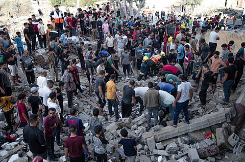 Palestinians look fro survivors after Israeli airstrikes in Khan Younis, Gaza Strip, Monday, Oct. 16, 2023. (Photo | AP)