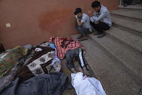 Palestinians mourn relatives killed in the Israeli bombardment of the Gaza Strip in a morgue in Khan Younis. (Photo | AP)