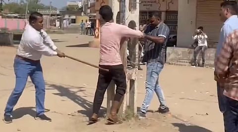 FILE - A Muslim man being beaten up allegedly by a policeman in Gujarat's Kheda district. (Video grab)