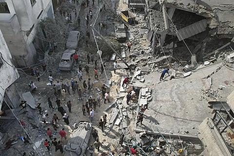 Palestinians look for survivors after the Israeli bombardment of the Gaza Strip in Deir Al-Balah. (Photo | AP)