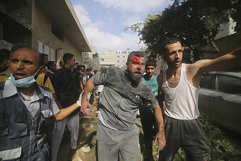 Palestinians are evacuated from buildings hit in the Israeli bombardnment of the Gaza Strip in Rafah, Oct 22, 2023. (Photo | AP)