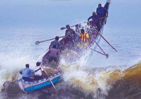 An artisanal boat used for shore seine fishing cuts through waves early in the morning on a monsoon day. (Still from the documentary ‘Crashing Waves’.