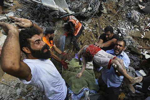 Palestinians carry the body of a dead child on Gaza City, Oct 24, 2023. (Photo | AP)