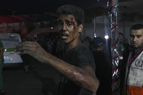 An injured Palestinian man arrives at the al Shifa hospital following Israeli airstrikes on Gaza City. (Photo | AP)