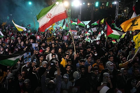 Iranian demonstrators wave Iranian, Palestinian and Lebanon's militant Hezbollah group flags in a pro-Palestinian rally at the Felestin Sq. in Tehran, Oct. 20, 2023. (Photo | AP)