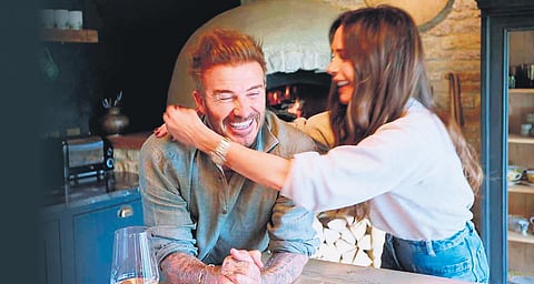 David Beckham with wife and fashion designer Victoria at home
