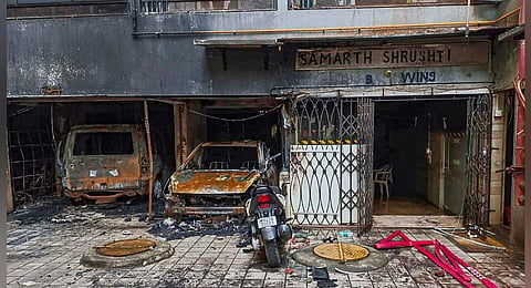 Charred vehicles after a fire broke out in a multi-storey residential building in Goregaon area Mumbai | PTI