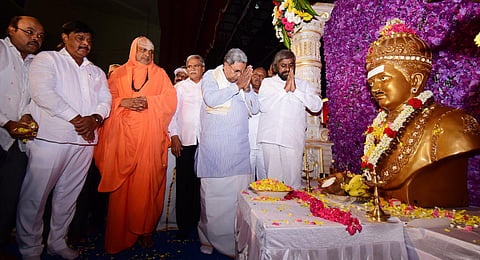 CM offers tributes to Basavanna at Basava Jayanti celebrations in Mysuru. Suttur Seer Sri Shivarathri Deshikendra Swami, and ministers HC Mahadevappa and Eshwar Khandre look on| Udayashankar S